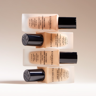 several corrective skin foundations stacked on a beige background