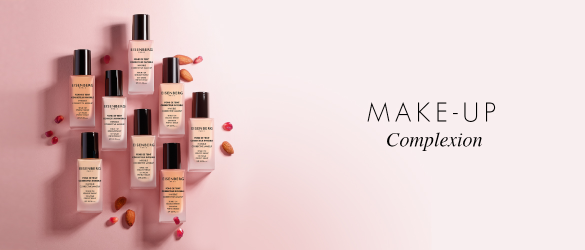 range of skin foundations with almond and pomegranate seeds on a bright pink background
